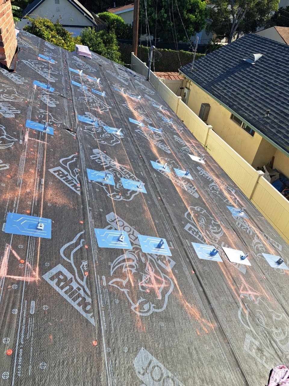 RhinoRoof U20 underlayment install on a residential sloped roof with tile clips and anchor pads pre-set for solar mounting — PBG roofing work, Los Angeles.